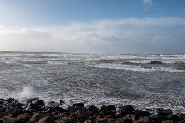 Fototapeta na wymiar Powerful ocean waves. Strandhill, county Sligo, Ireland. Cloudy sky.