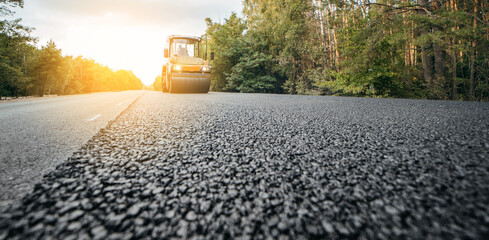 Vibratory asphalt rollers compactor compacting new asphalt pavement. Road service repairs the...