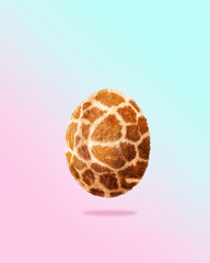 Creative Easter concept of animal giraffe print egg. Fashion style winner egg on pastel background.