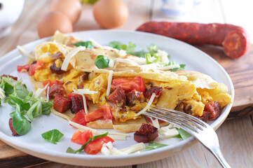 Crepe filled with scrambled eggs, tomatoes, cheese and fried chorizo salami