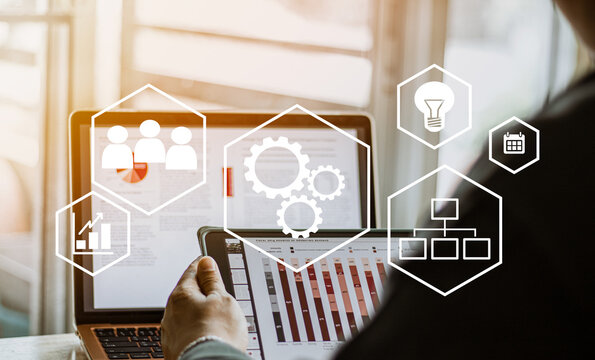 automation and workflow concept, businessman using laptop and digital taplet for working  and process workflow development on virtual screen.
