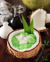 Fototapeta na wymiar Bubur Sumsum Pandan, Green Rice Porridge with Coconut Milk and Brown Sugar Sauce