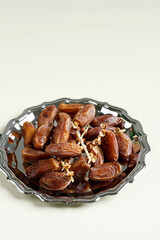 Tunisian Dates or Kurma Tunisia isolated on Cream Background for Breaking the Fast or Buka Puasa.