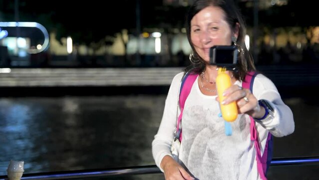 Woman dancing and smiling in Clarke Quay, Singapore