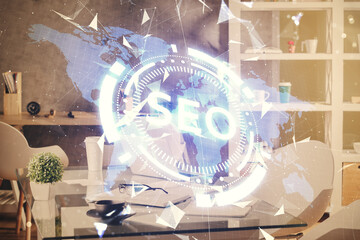 Double exposure of SEO drawing and office interior background. Concept of Search optimization engine.