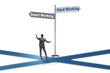 Fototapeta premium Businessman at the crossroads on working smart or hard