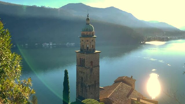 Mountain View and Church of Santa Maria del Sasso on Lake Lugano in a Sunny Day in Morcote, Ticino, Switzerland.