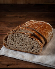 Sliced loaf of sourdough bread on the wooden table
