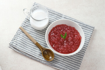 Bubur Mutiara, Bubur Sagu Mutiara, Indonesian Dessert Porridge. Made from pearl sago (sagu mutiara), sugar, pandan leaves, and coconut milk. Very famous during Ramadhan. Selective focus image.
