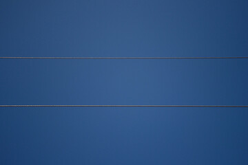 Power line wires against the blue sky. Wires covered with frost, frosty winter day