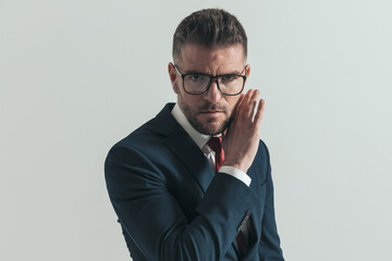 serious man with beard and glasses covering face and gossiping