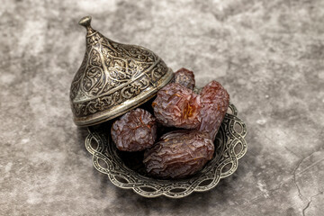 Date fruit on a dark background. Date fruits on a rustic serving plate