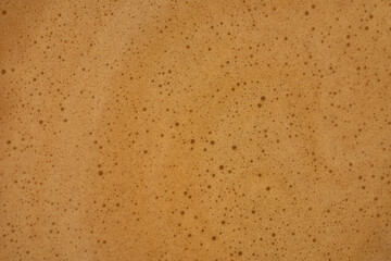 Cream of freshly brewed coffee background or texture