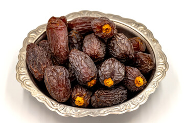 Date fruit isolated on a white background. Date fruits on a rustic serving plate