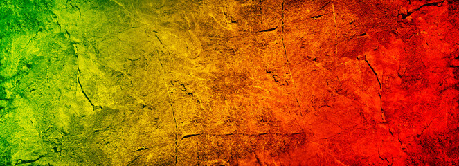 Green yellow orange red abstract background. Gradient.Toned rough old stone texture surface. Close-up. Colorful background with copy space for design. Wide banner. Panoramic.