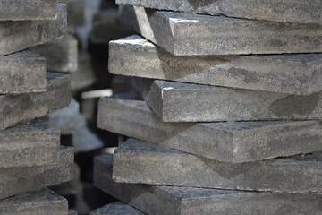 Stacked gray paving slabs in diagonal arrangement on construction site in Berlin-Germany.