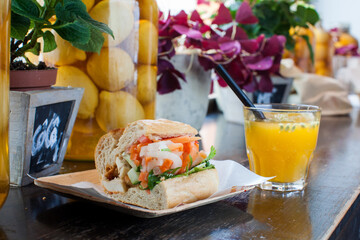 Vegetable and chicken sandwich served with orange juice 