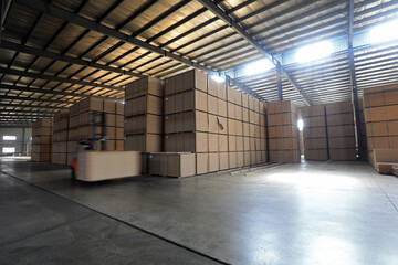 Workers drive forklifts to transport density board products in the factory, North China