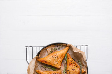 Tasty Uzbek samsa on white wooden background