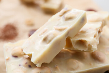 Pieces of tasty chocolate with hazelnuts, closeup