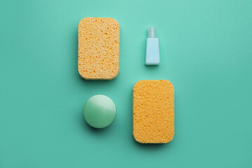 Bath sponges and cosmetics on color background