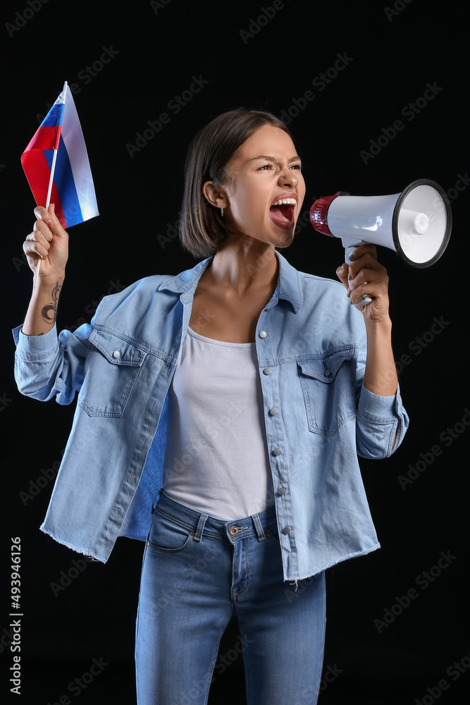 Sticker Young woman with flag of Russia and megaphone on dark background