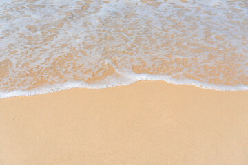 Top view of soft wave on sandy beach. Copy space