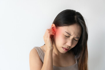 Asian woman with sore ear suffering from otitis with red accent. Stressed frowning young girl from strong ear pain feeling painful discomfort isolated on white studio background. Copy space, closeup