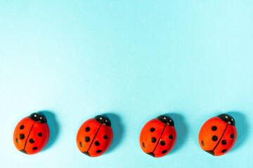 ladybugs figurines on a colored surface