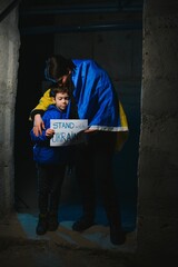 Loving mother holding her child in the bomb shelter. The war in Ukraine. Russia's aggression.