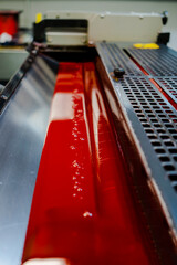 Color and glossy rollers of offset printing machine. offset ink colour.  magenta red . Photo taken...