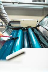 Color and glossy rollers of offset printing machine. offset ink colour.  Cyan. Photo taken...