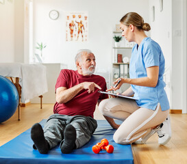 nurse doctor senior care exercise physical therapy exercising help assistence retirement home physiotherapy strech band clinic therapist elderly man