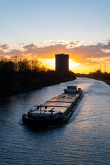 Cargo vessel on inland ship canal “Rhein-Herne-Kanal“ at blue hour after sunset in Oberhausen...