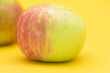 apple isolated on yellow background. Clipping path.