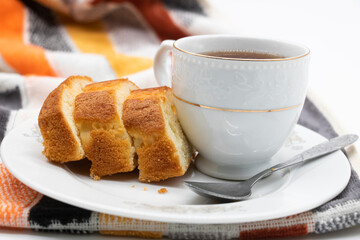 slices of freshly baked pound cake with tea over on white background