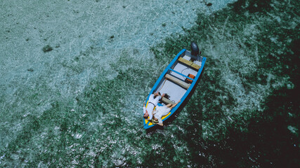 Two lovers in a boat in the Seychelles, in the middle of the Indian Ocean