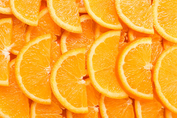 Many ripe orange slices as background, closeup
