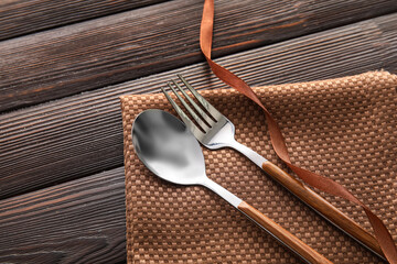 Elegant cutlery on wooden background