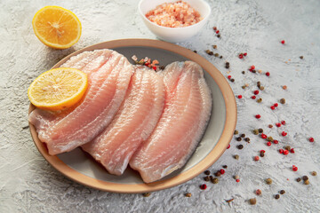 Tilapia fish fillet with spices and lemon. Healthy food rich in proteins.