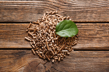 Pile of wood pellets on wooden background