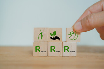 hand arranged wooden cube block over reduce, reuse and recycle text for save world, environmental...