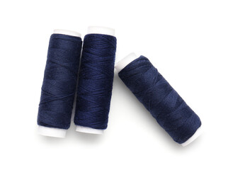 Blue thread spools on white background