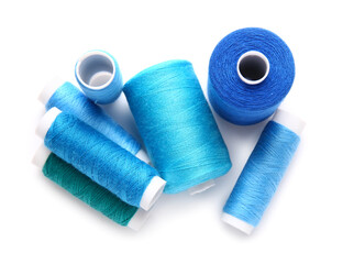 Different thread spools on white background