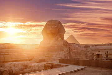 Fototapeta na wymiar Sphinx and pyramids Giza, Egypt sunset sky Main tourist view