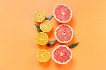 Fresh orange and grapefruit slices on color background