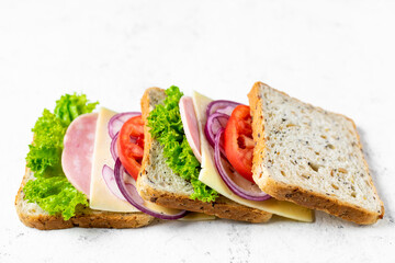 sandwich with ham cheese tomatoes lettuce onions. Ingredients for a sandwich with whole grain bread