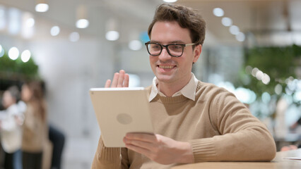 Portrait of Young Man Celebrating Success Tablet in Office 