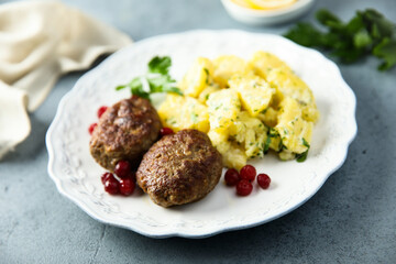 Homemade meatballs with cranberry and potato salad