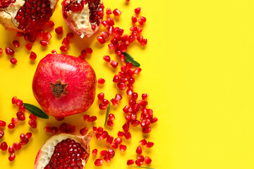 Tasty ripe pomegranate on yellow background